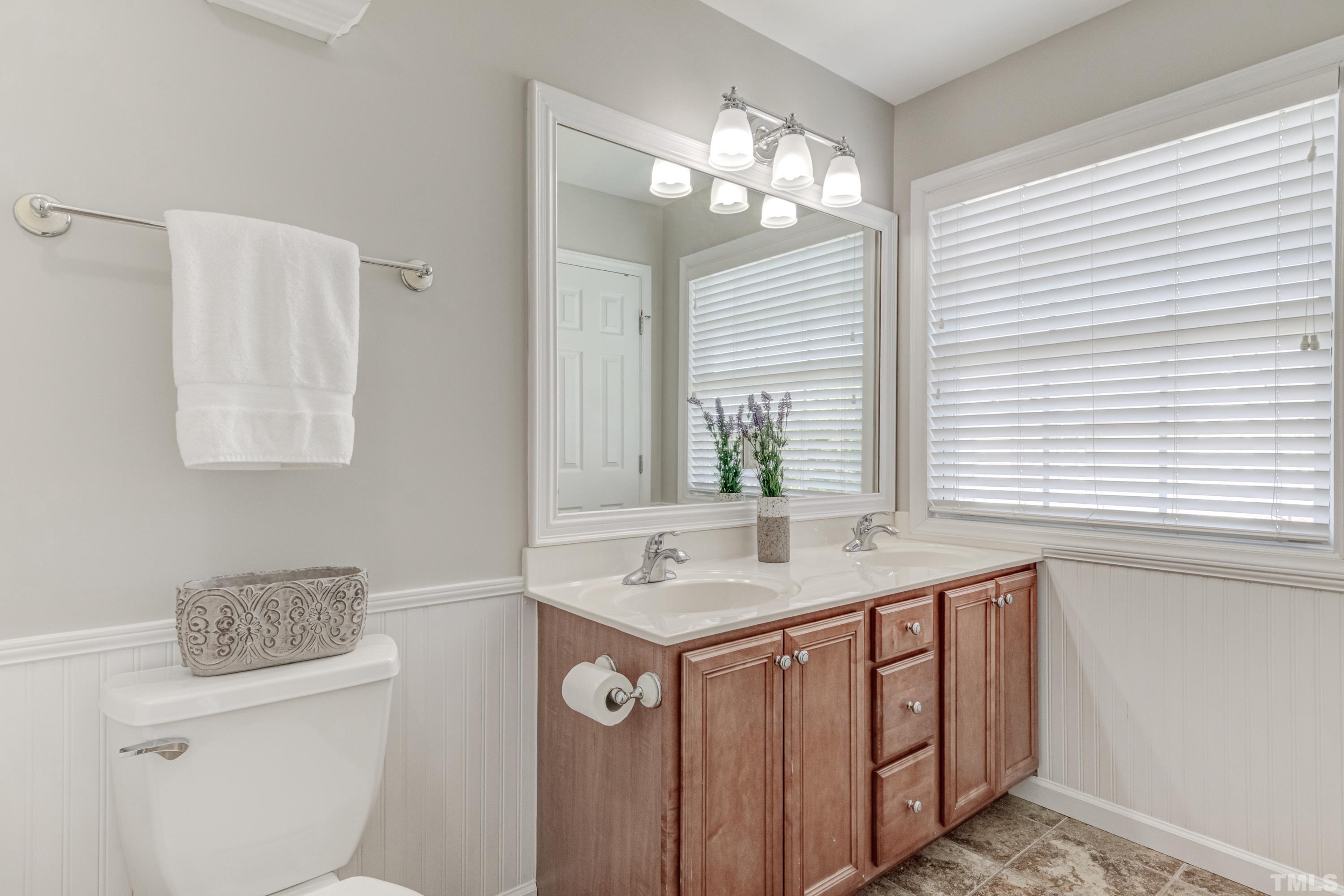 2101 Piney Brook Road, Unit 107 Raleigh, NC 27614 - Photo 26 of 37 a bathroom with a sink a toilet and a mirror