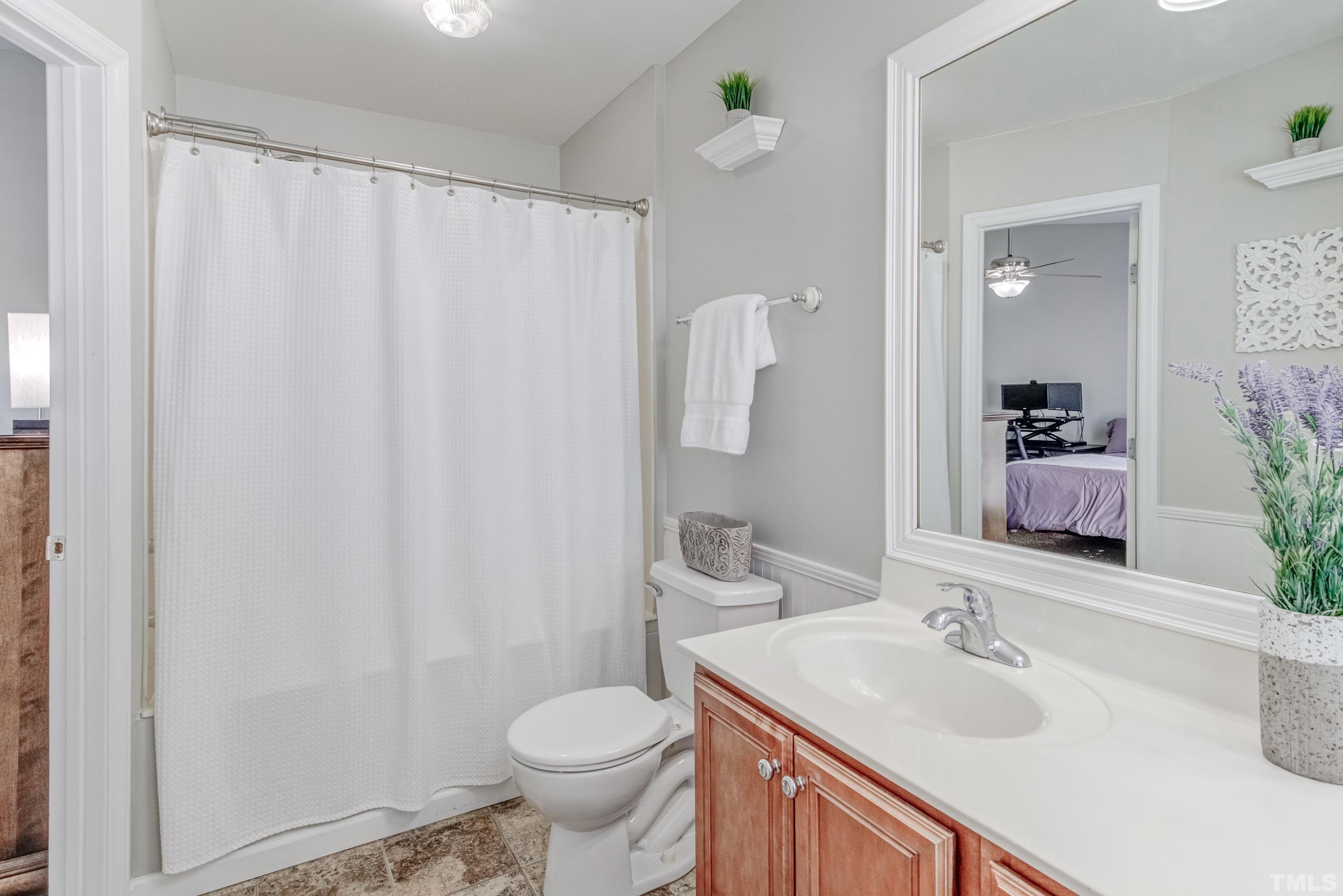2101 Piney Brook Road, Unit 107 Raleigh, NC 27614 - Photo 27 of 37 a bathroom with a sink a toilet and a mirror
