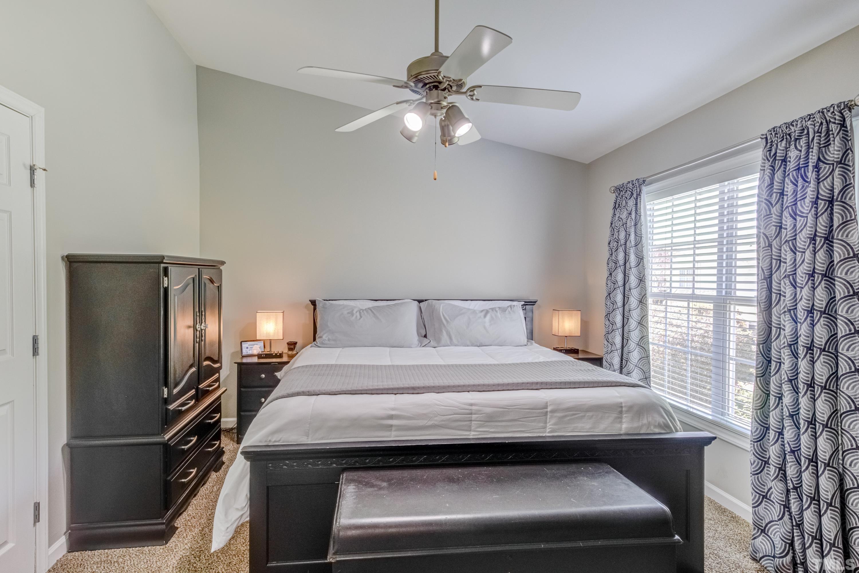 2101 Piney Brook Road, Unit 107 Raleigh, NC 27614 - Photo 29 of 37 a bedroom with a bed and a chandelier