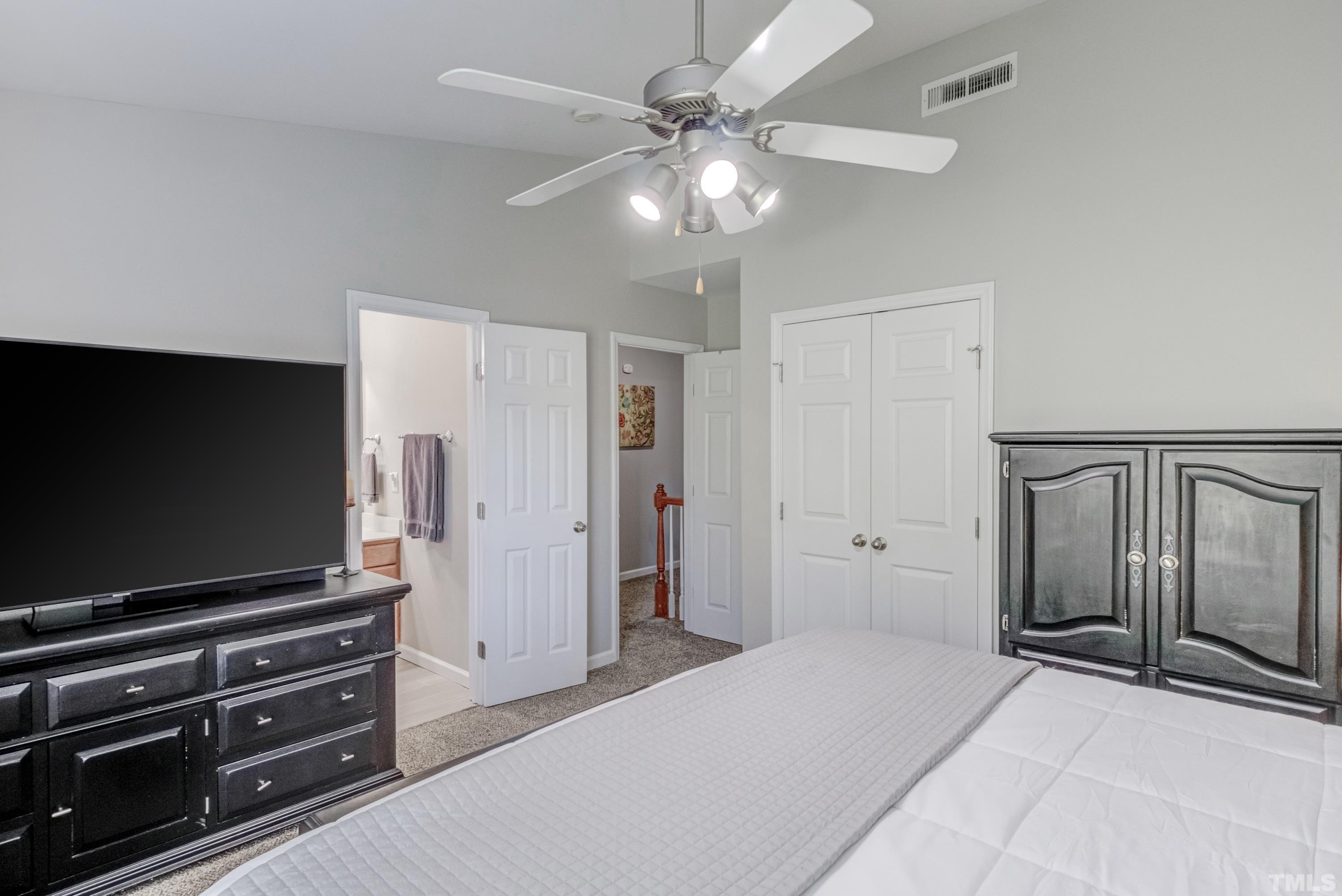 2101 Piney Brook Road, Unit 107 Raleigh, NC 27614 - Photo 30 of 37 a bedroom with furniture and a flat screen tv