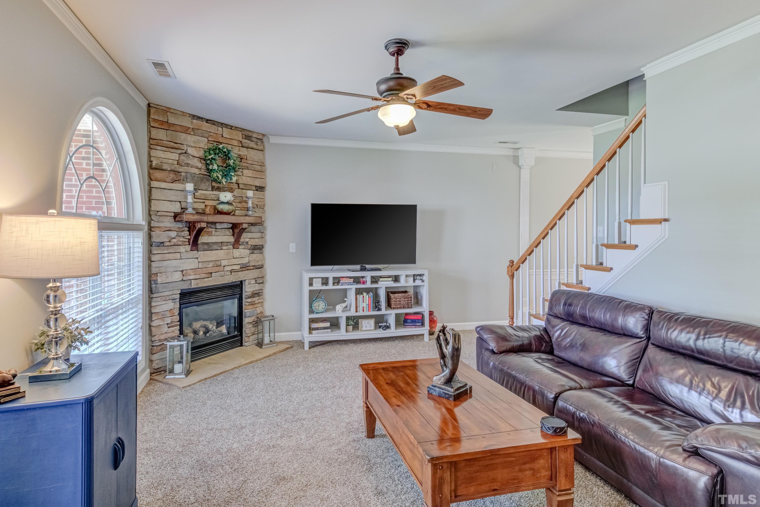 2101 Piney Brook Road, Unit 107 Raleigh, NC 27614 - Photo 5 of 37 a living room with fireplace furniture and a flat screen tv