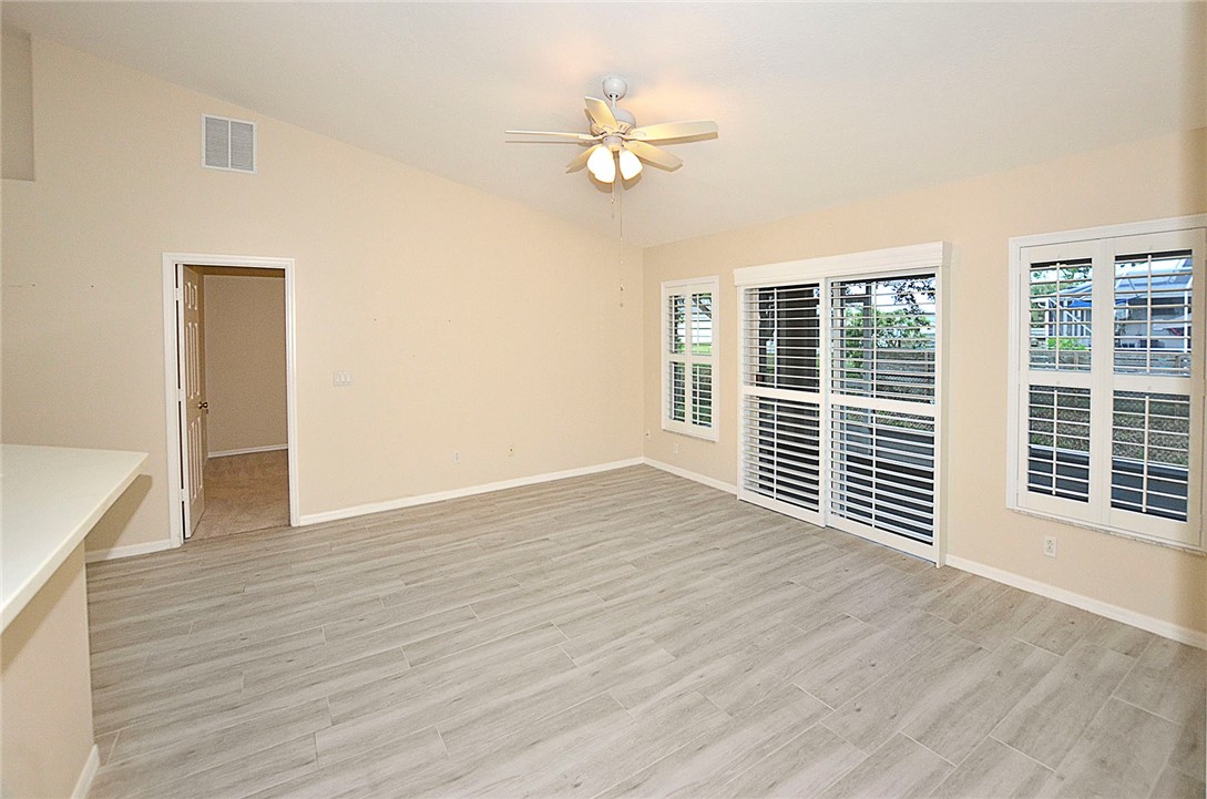 1210 Clearmont Street Sebastian, FL 32958 - Photo 11 of 31 a view of an empty room with a window and wooden floor