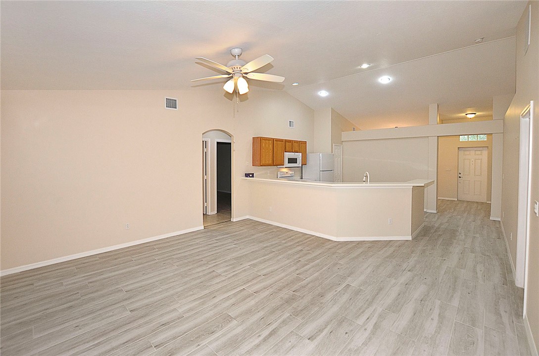 1210 Clearmont Street Sebastian, FL 32958 - Photo 12 of 31 a view of a kitchen with wooden floor and a ceiling fan