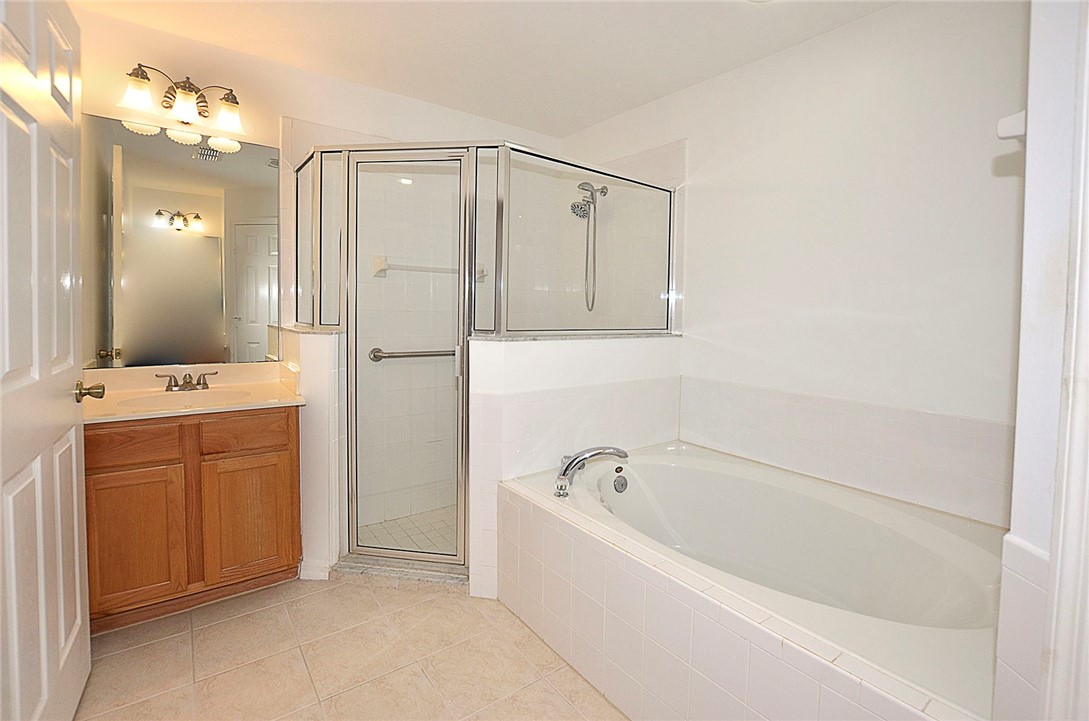 1210 Clearmont Street Sebastian, FL 32958 - Photo 16 of 31 a bathroom with a bathtub a mirror a shower and vanity