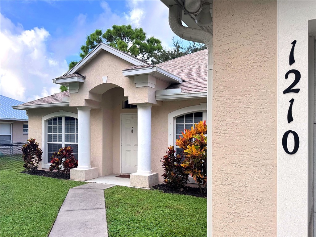 1210 Clearmont Street Sebastian, FL 32958 - Photo 2 of 31 a front view of a house with garden