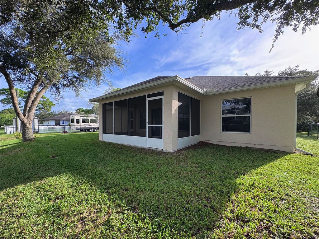 1210 Clearmont Street Sebastian, FL 32958 - Photo 27 of 31 a view of a house with a garden
