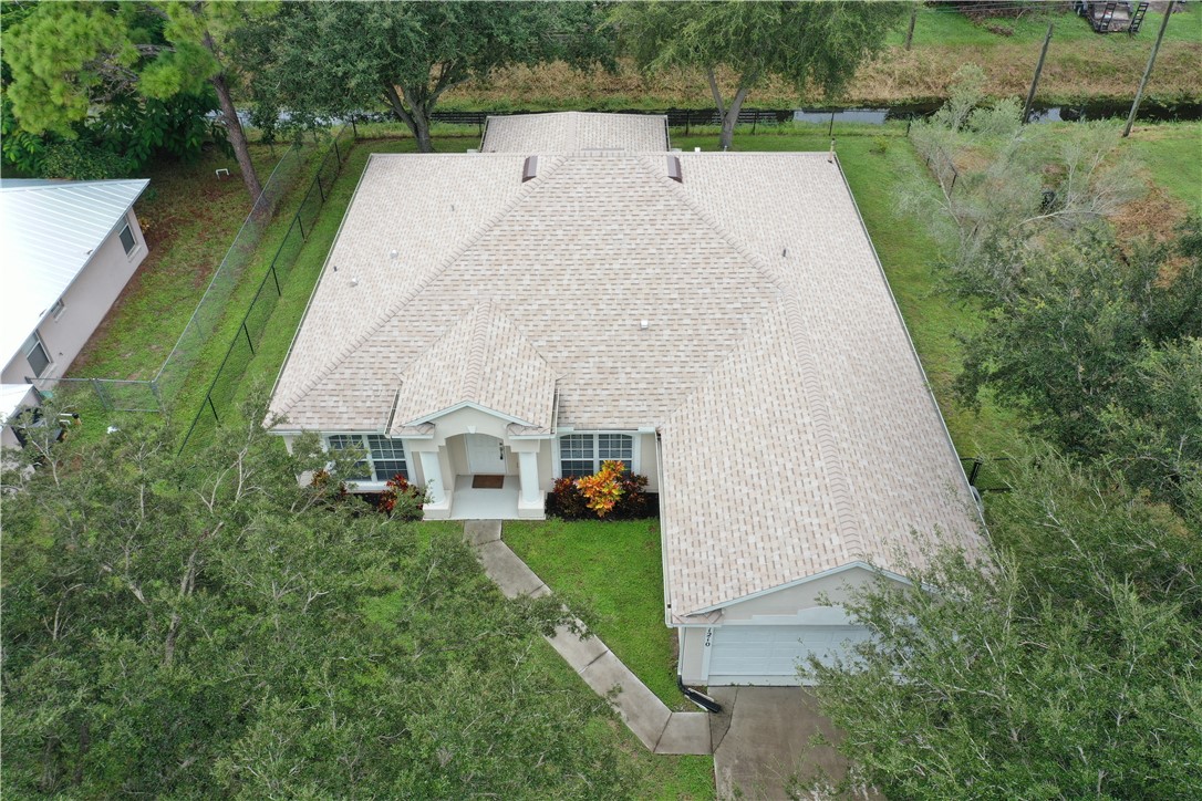 1210 Clearmont Street Sebastian, FL 32958 - Photo 3 of 31 an aerial view of a house with a yard and lake view