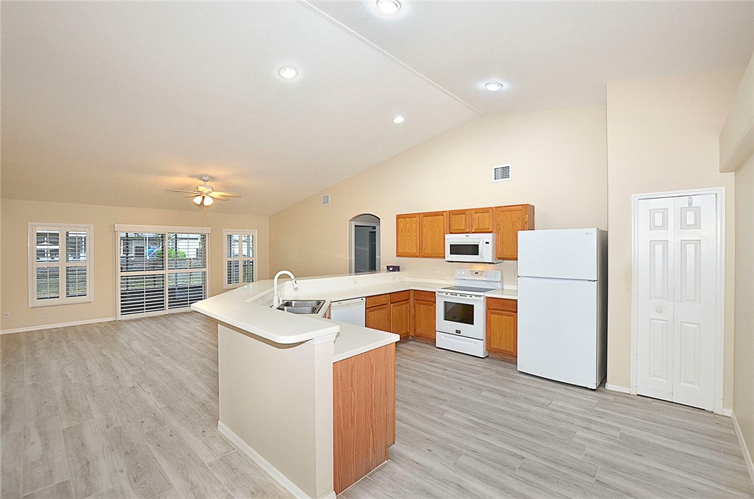 1210 Clearmont Street Sebastian, FL 32958 - Photo 7 of 31 a kitchen with stainless steel appliances granite countertop a sink and wooden floor
