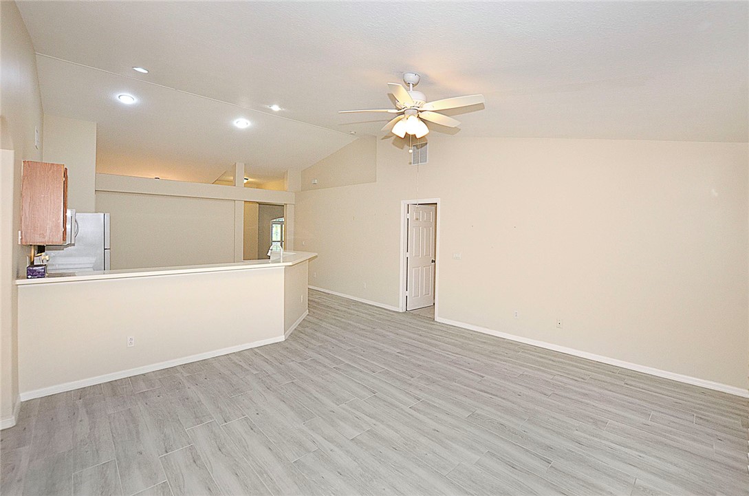 1210 Clearmont Street Sebastian, FL 32958 - Photo 10 of 31 a view of a kitchen with wooden floor and a ceiling fan