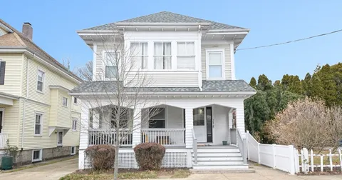 a front view of a house with large windows