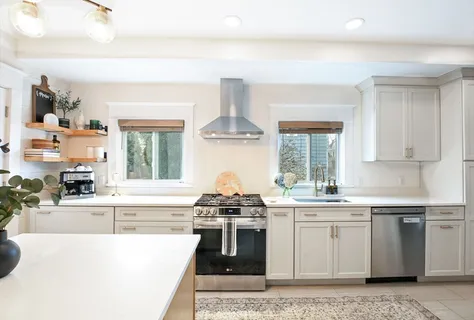 a kitchen with stainless steel appliances a stove sink and cabinets