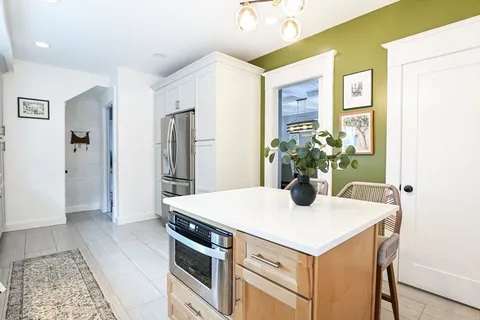 a kitchen with a refrigerator and a stove