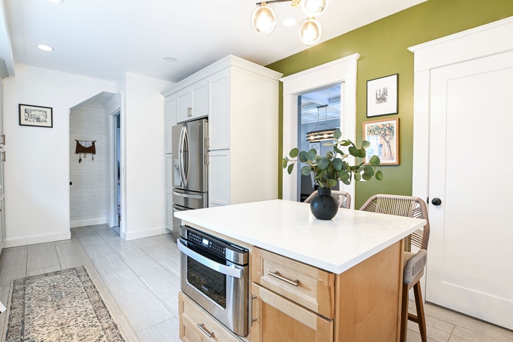 265 Maple Street New Bedford, MA 02740 - Photo 13 of 35 a kitchen with a refrigerator and a stove