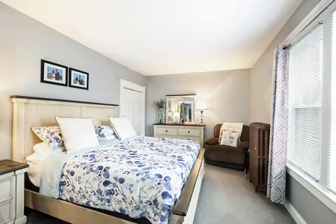 a bedroom with a large bed and a couch