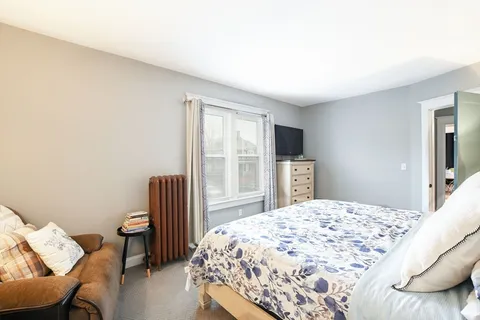 a bedroom with a bed and a chair