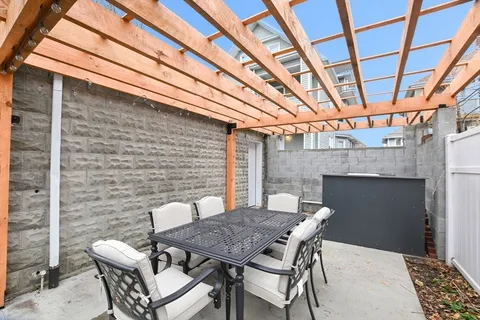 a patio with a table and chairs