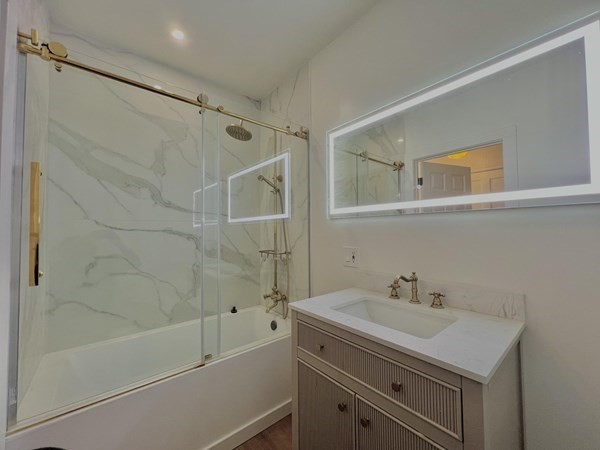 31 Carleton Street Attleboro, MA 02703 - Photo 7 of 14 a bathroom with a sink and a bathtub