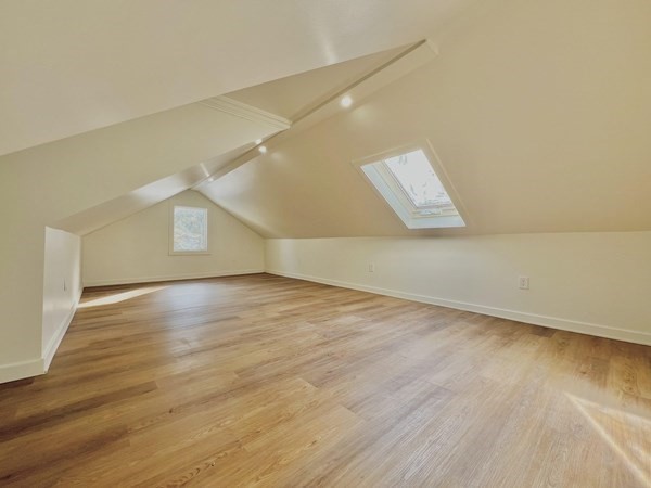 31 Carleton Street Attleboro, MA 02703 - Photo 8 of 14 a view of an empty room with wooden floor and a window