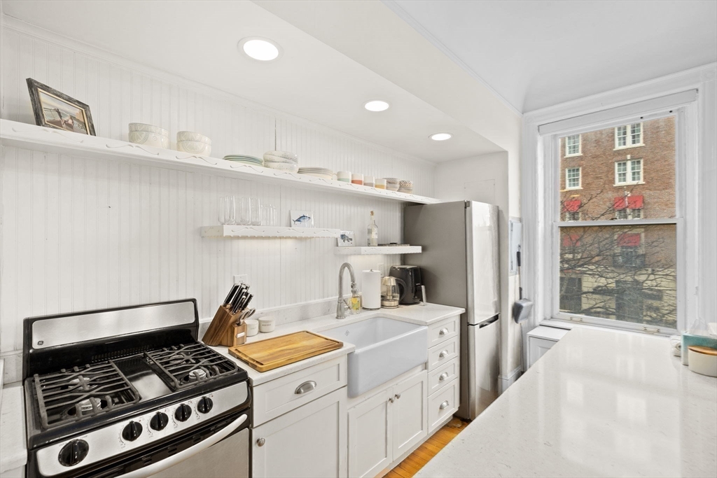 362 Commonwealth Avenue, Unit 2H Boston, MA 02115 - Photo 6 of 20 a kitchen that has a lot of cabinets in it and wooden floors
