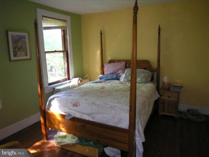 5007 Morello Road Baltimore, MD 21214 - Photo 21 of 28 a bed sitting in a bedroom next to a window