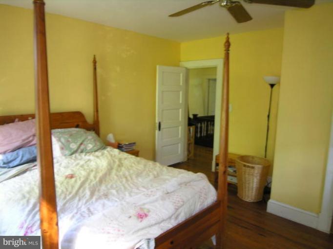 5007 Morello Road Baltimore, MD 21214 - Photo 22 of 28 a bedroom with a bed and wooden floor