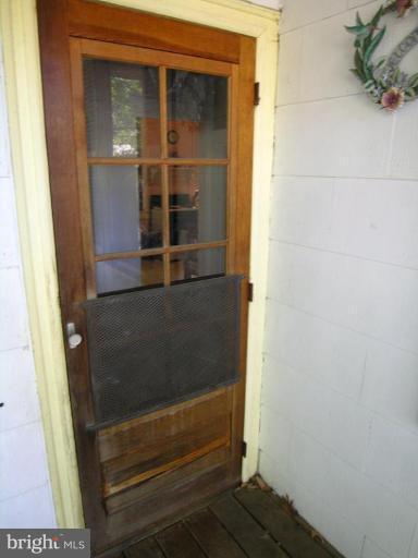 5007 Morello Road Baltimore, MD 21214 - Photo 9 of 28 a bathroom with a glass door shower and a sink