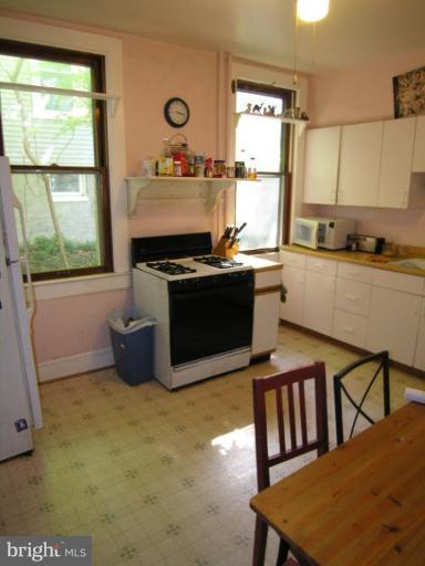 5007 Morello Road Baltimore, MD 21214 - Photo 10 of 28 a kitchen with stainless steel appliances granite countertop a stove a sink and a microwave