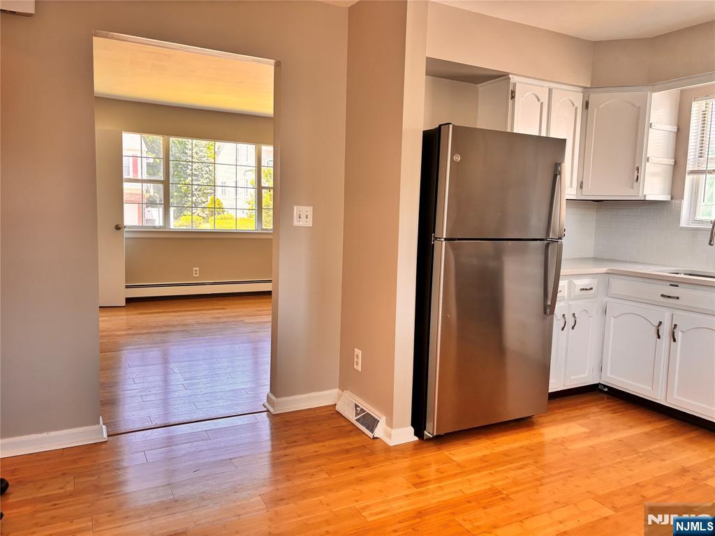21 Wanamaker Avenue, Unit 1 Waldwick, NJ 07463 - Photo 4 of 13 a view of a kitchen with a refrigerator and wooden floor