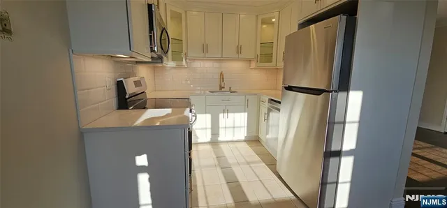 a kitchen with a sink and refrigerator