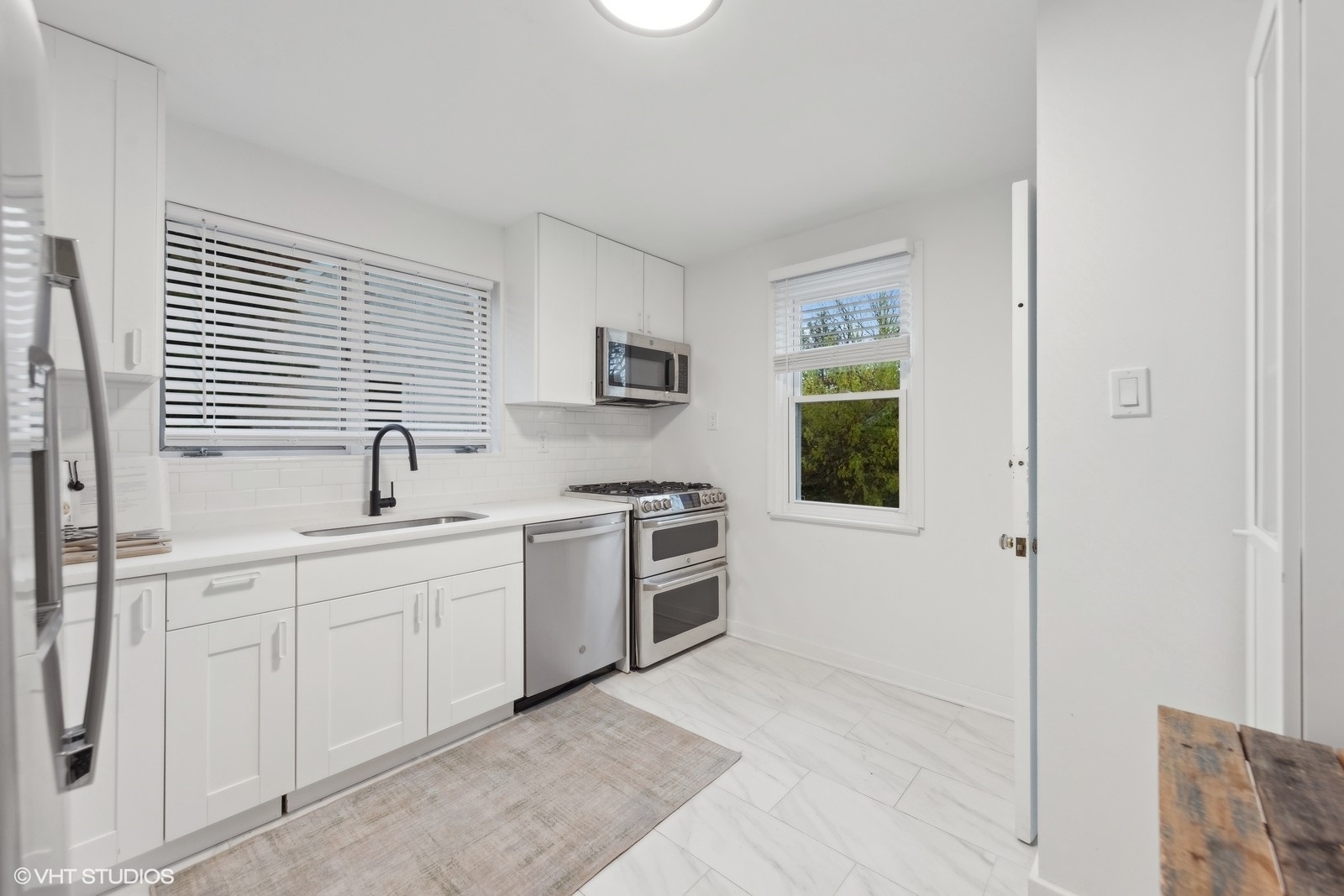 166 Northgate Road Riverside, IL 60546 - Photo 7 of 15 a kitchen with a sink cabinets stainless steel appliances and a window