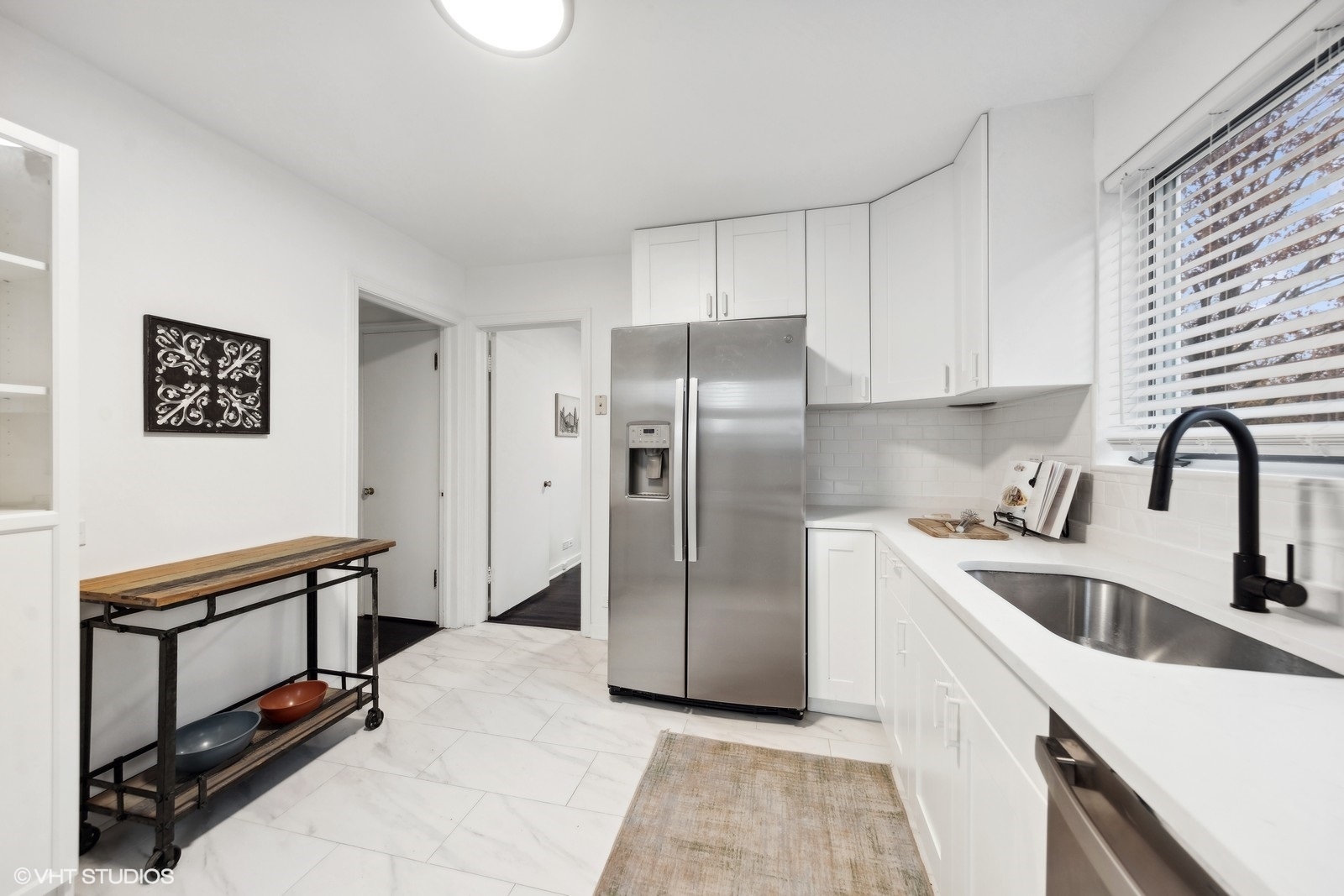 166 Northgate Road Riverside, IL 60546 - Photo 8 of 15 a kitchen with a sink cabinets and stainless steel appliances