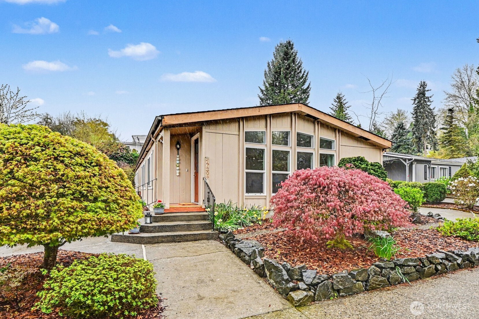 17308 Woodcrest Drive Northeast Bothell, WA 98011 - Photo 1 of 38 a front view of a house with garden