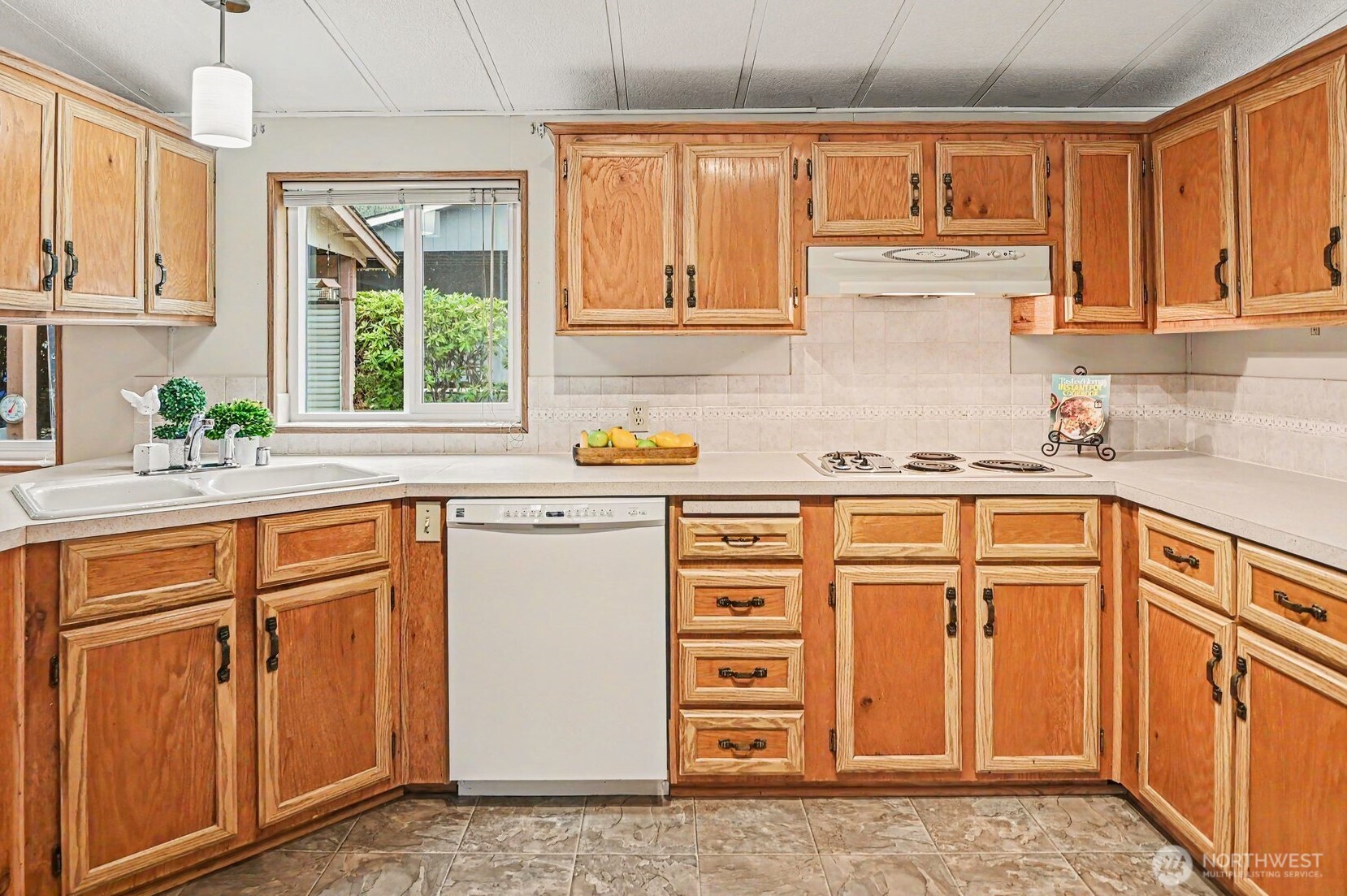 17308 Woodcrest Drive Northeast Bothell, WA 98011 - Photo 13 of 38 a kitchen with granite countertop a sink cabinets stainless steel appliances and a window