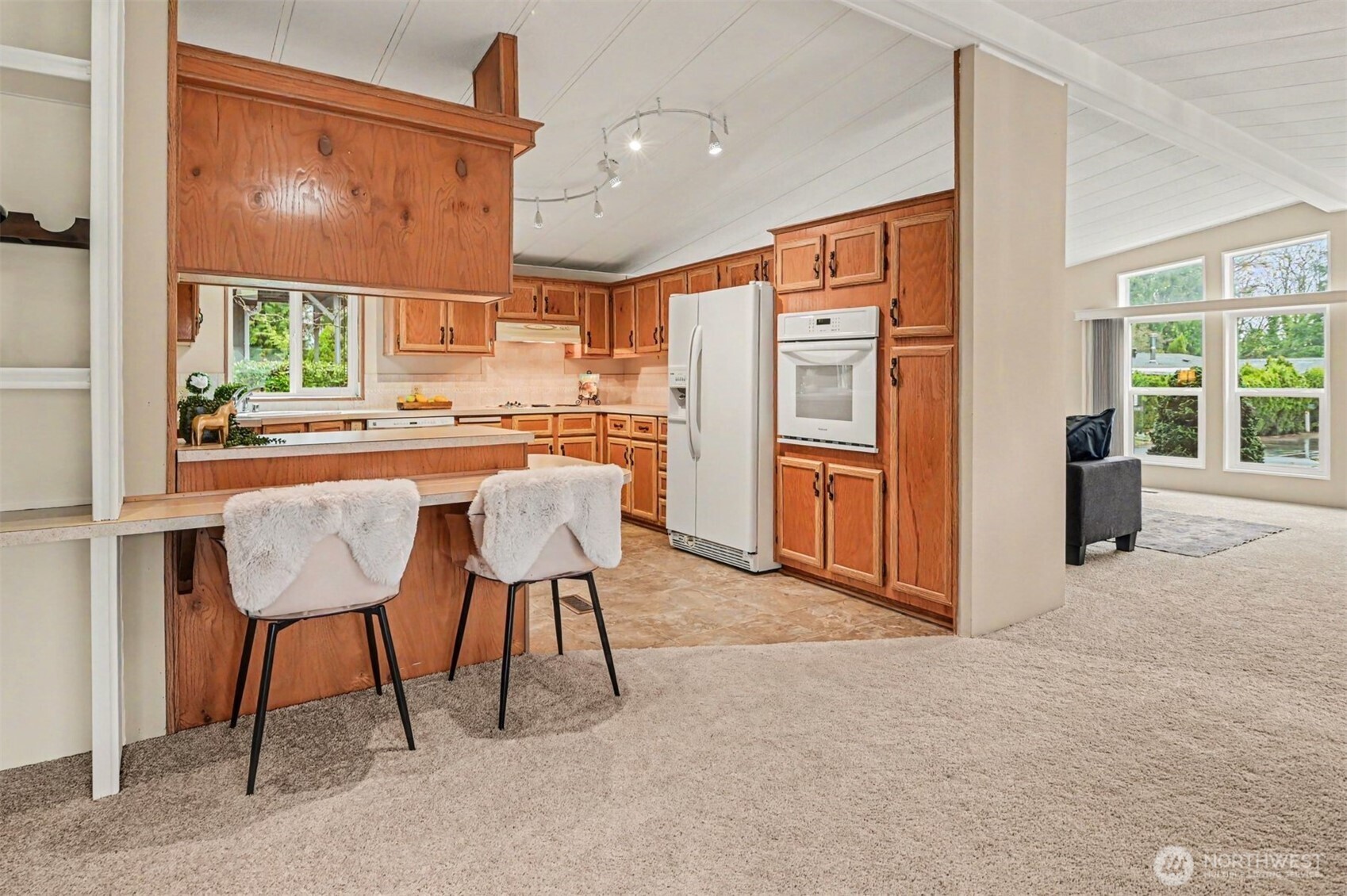 17308 Woodcrest Drive Northeast Bothell, WA 98011 - Photo 18 of 38 a kitchen with stainless steel appliances granite countertop a refrigerator and a stove top oven