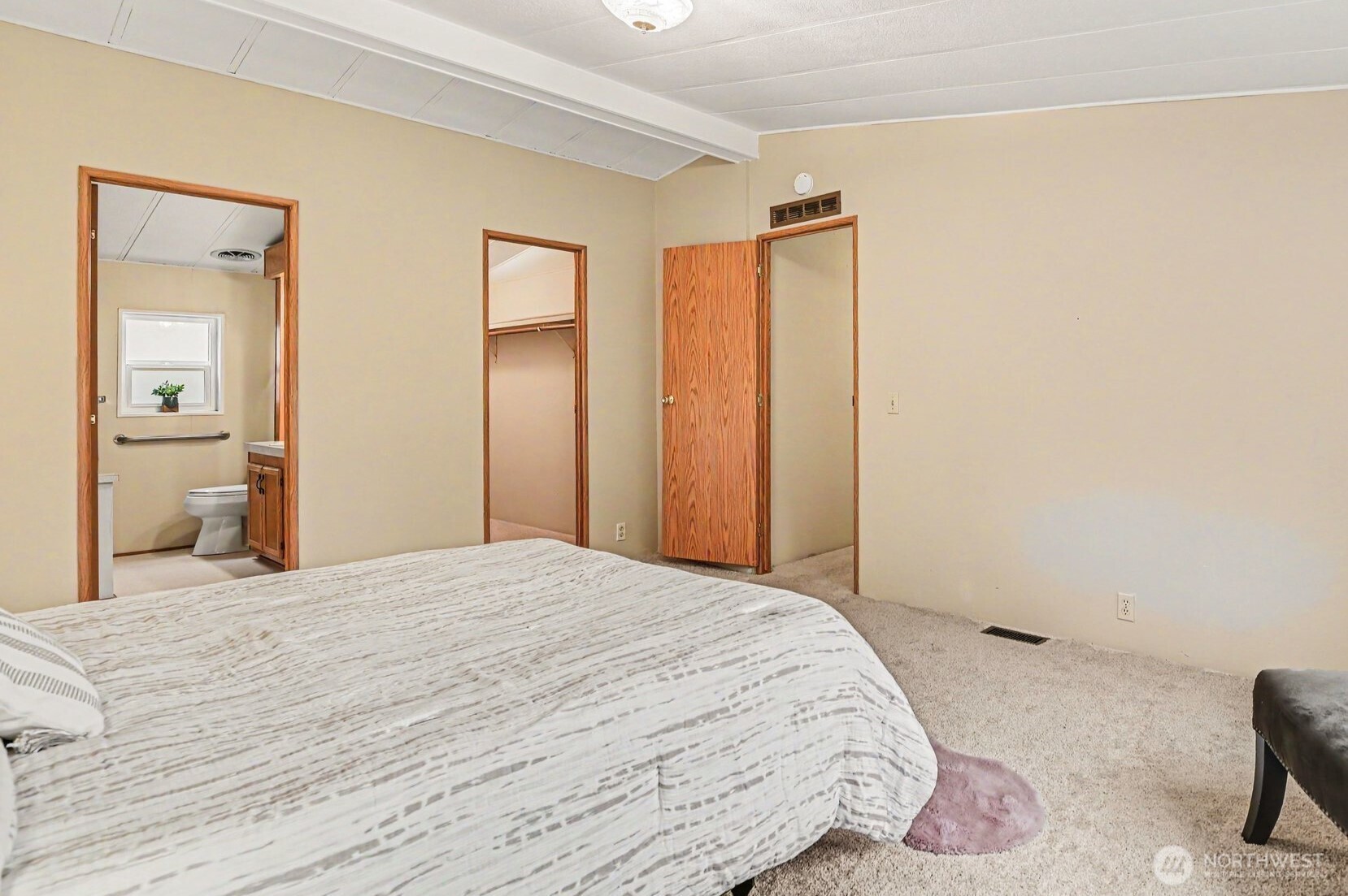 17308 Woodcrest Drive Northeast Bothell, WA 98011 - Photo 24 of 38 a bedroom with a bed and a mirror