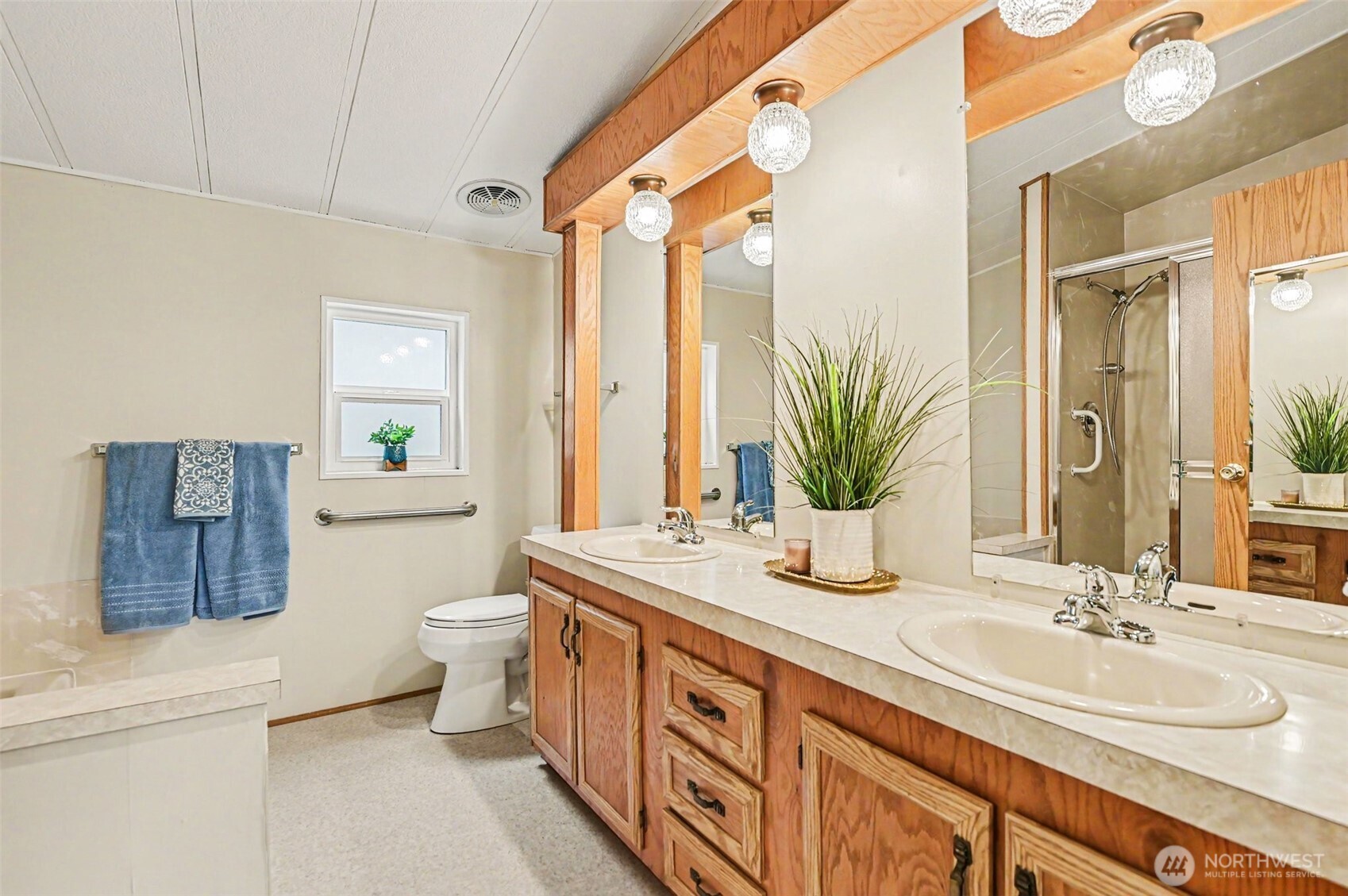 17308 Woodcrest Drive Northeast Bothell, WA 98011 - Photo 25 of 38 a bathroom with a double vanity sink toilet and a mirror