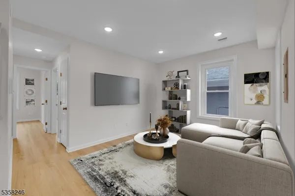 a living room with furniture and a potted plant