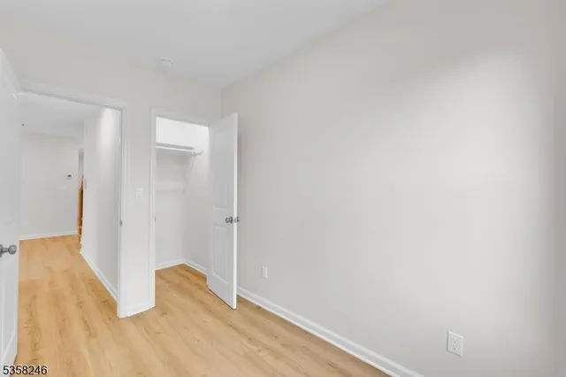 a view of a room with wooden floor