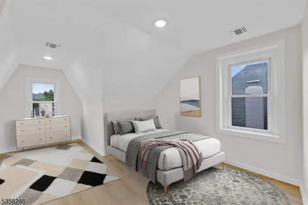 a view of a small space with wooden floor and a window