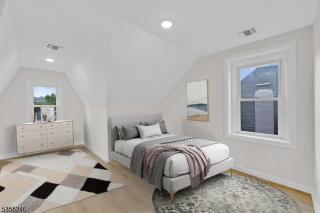 a view of a small space with wooden floor and a window