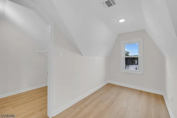 a bedroom with a bed and lamp