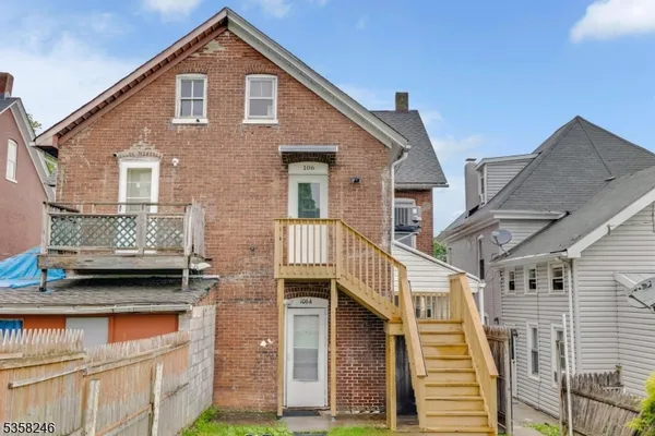 a view of a house with a big yard and large trees