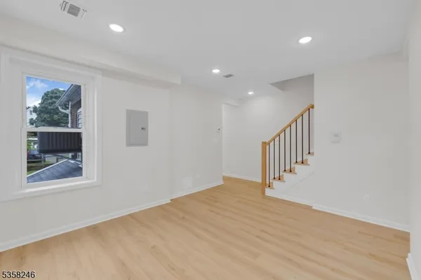 a view of an entryway with wooden floor