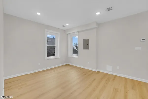 a view of an empty room with glass door