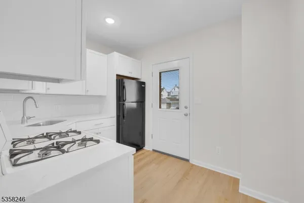 a kitchen with a sink a stove and refrigerator