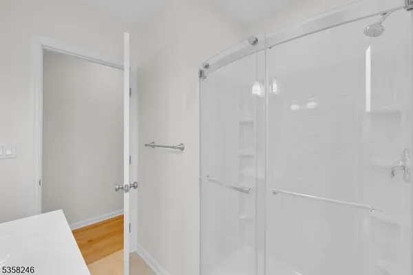 a bathroom with a shower and a bath tub