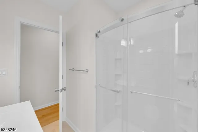 a bathroom with a shower and a bath tub