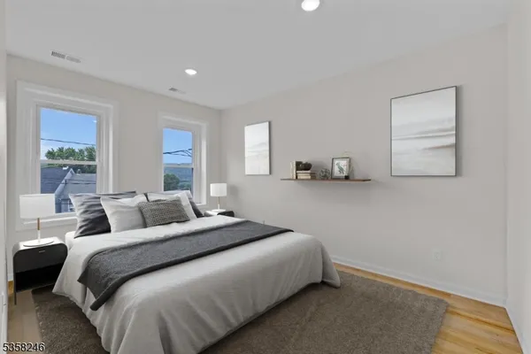 a bedroom with a bed and a painting