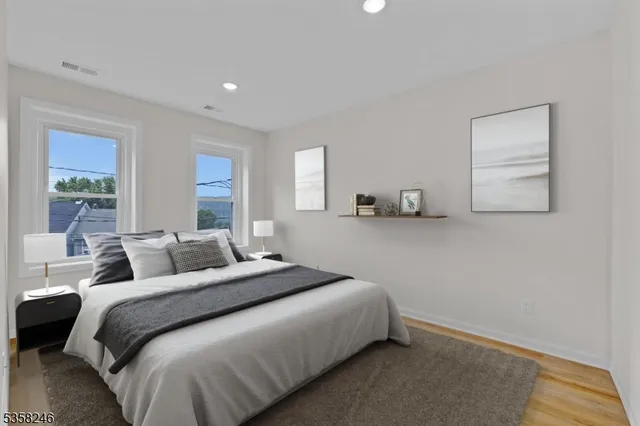 a bedroom with a bed and a painting