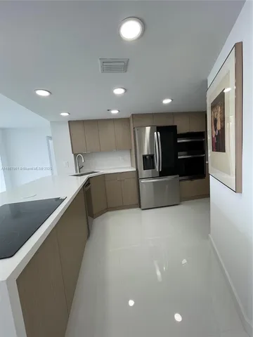 a large building with stainless steel appliances a large counter top a stove and a refrigerator